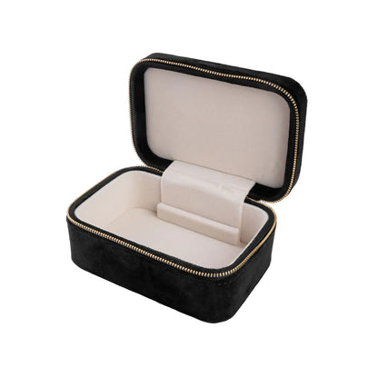 Svart smúkkuskrín við gull lýblási. Víst opið.