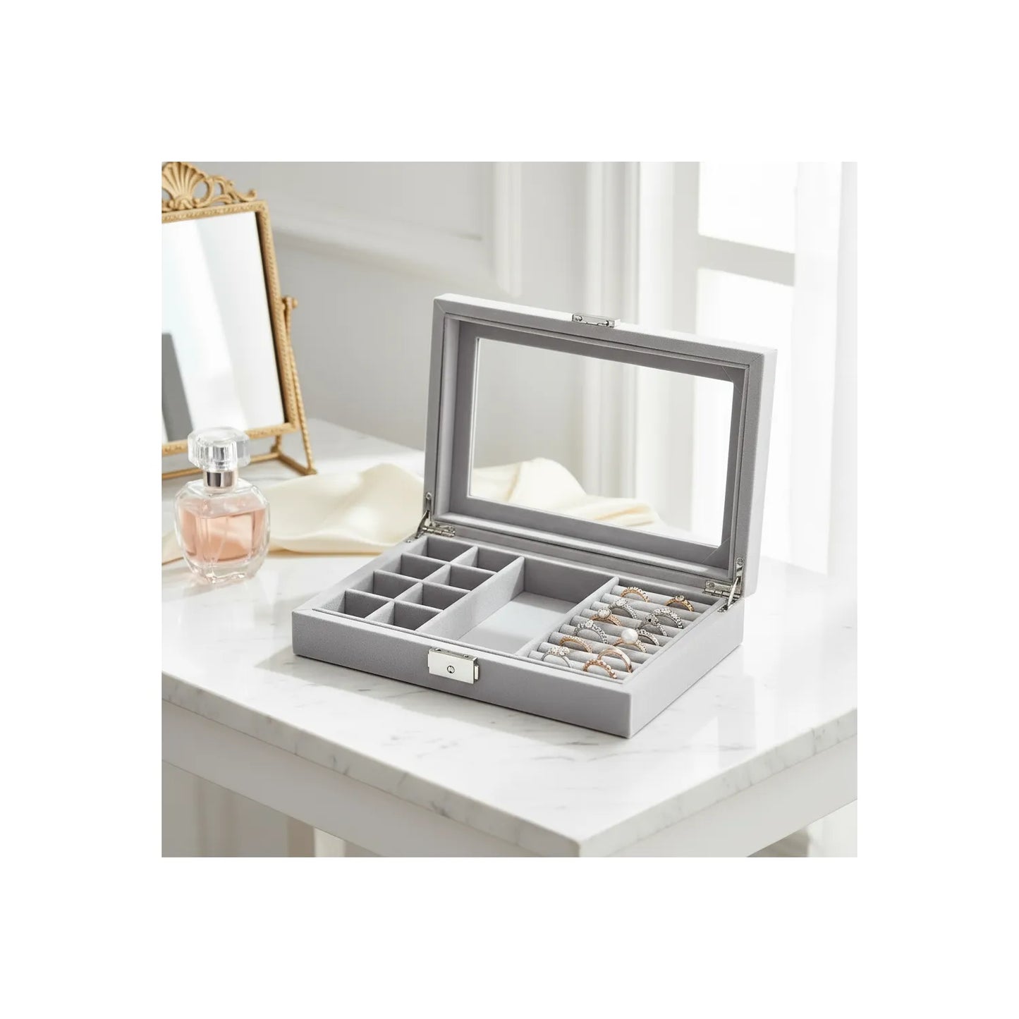 Opið grátt smúkkuskrín við glasrútið. Parfuma, luktilsi og eitt spegl er í bakrundini. 